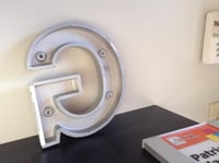Cast metal letter back